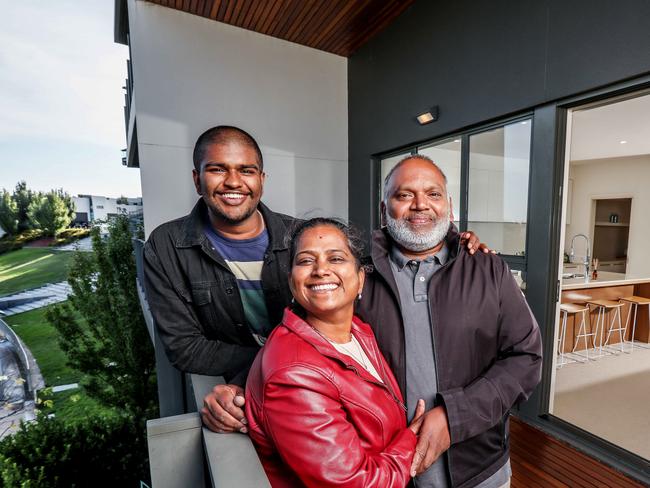 Melbourne home values have hit a record high after plunging during the COVD-19 pandemic. Vendors Ramesh and Manju are selling their Mulgrave family home, which overlooks Hawthorn's training ground, at auction tonight and cashing in on the hot market. Pic of whole family at their home.  L to R Manju (red jacket), Ramesh and Vishal (son). Picture: Tim Carrafa