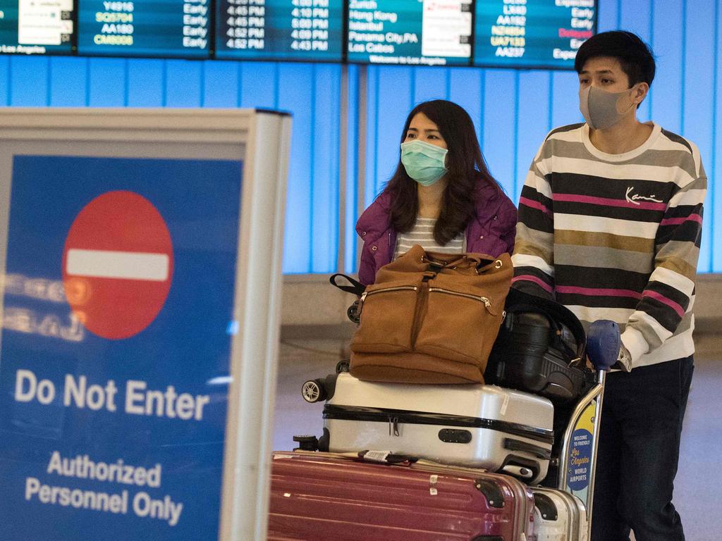 Passengers wear masks to protect against the spread of the virus at the Los Angeles International Airport, California. Picture: Mark Ralston/AFP