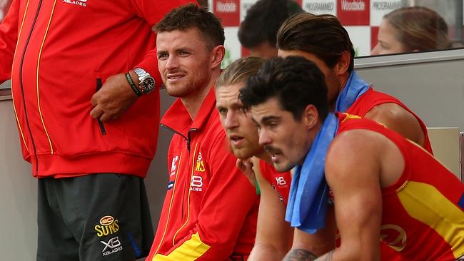 Pearce Hanley on the Gold Coast bench after being injured.