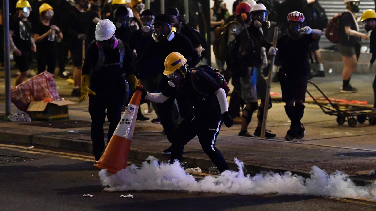 A protester covers up a tear gas canister during a demonstration against a controversial extradition bill in Hong Kong.