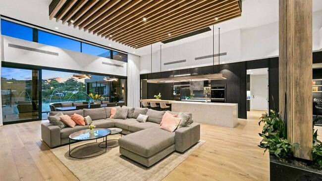 It modern mansion boasts coastal views and an outlook of the city skyline.