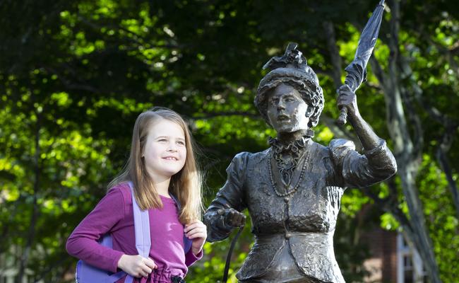 Malia Knox with the statue of suffragette Emma Miller in King George Square. She has written to the Women's Minister asking why there are so few statues honouring women. Picture: AAP/Renae Droop