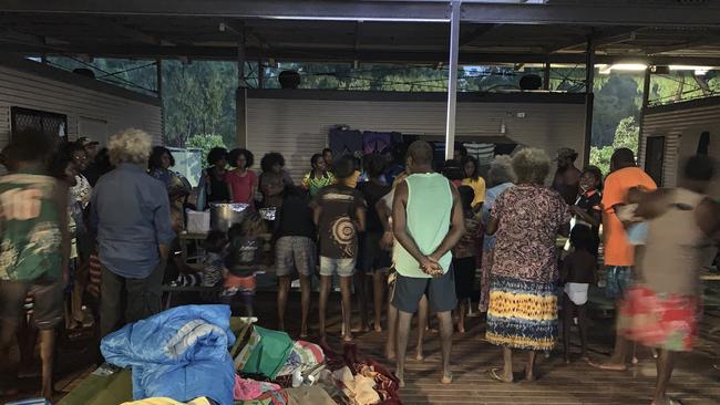 A supplied undated image obtained Friday, January 10, 2020 shows people gathered for a meal at a makeshift camp established by the Kapani Warrior group about 80km outside the town of Aurukun, Queensland. Concern is growing for hundreds of people who fled a riot sparked by an alleged murder in an isolated community of far north Queensland. (AAP Image/Supplied by Kapani Warrior)