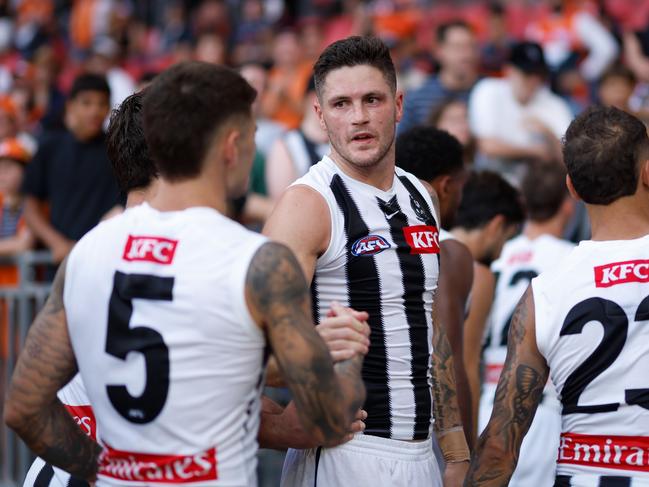 Jack Crisp and the Magpies leave the field on Sunday. Dylan Burns/AFL Photos via Getty Images)