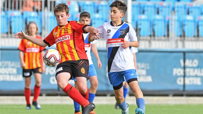 MetroStars’ William Donnelly shields the ball from Adelaide Comets’ Fabian Grelli during the under-13 cup final. Picture: Tom Huntley