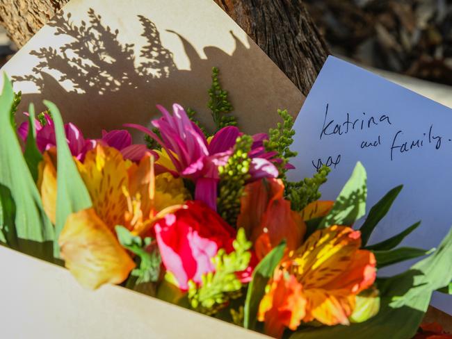 Flowers are left next to a police roadblock where police are investigating the death of seven people in suspected murder-suicide in Osmington. Picture: AAP Image/Richard Wainwright