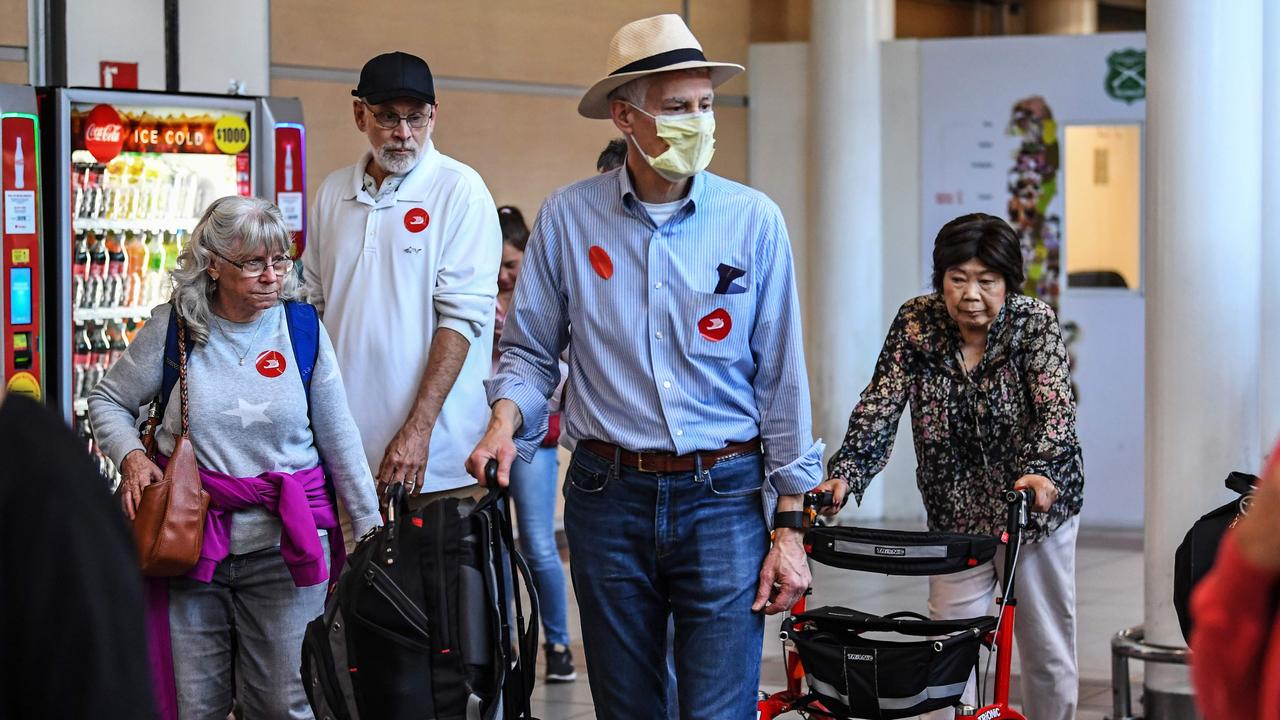 Travellers wear protective masks at the Arturo Merino Benítez International Airport in Santiago, Chile. Picture: Martin BERNETTI / AFP