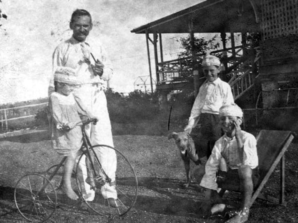 Albert Cook with daughter Althea and sons John and Tom at Christmas, 1920. The tricycle pictured is on display at Greenmount Homestead today.