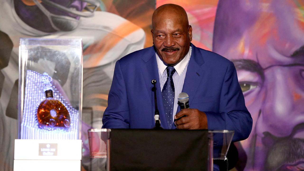 Jim Brown of the Cleveland Browns look on from the sidelines during