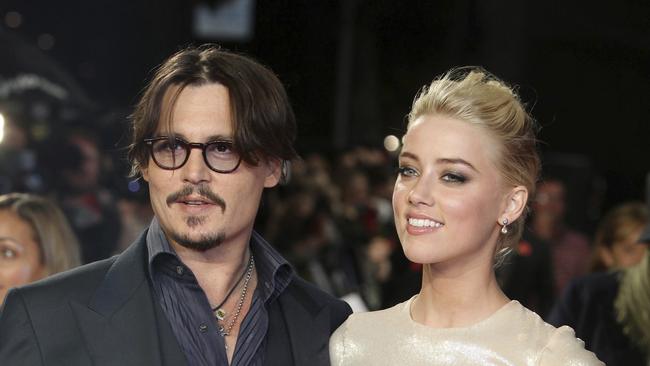 Johnny Depp and Amber Heard arrive for the European premiere of their film, "The Rum Diary". (AP Photo/Joel Ryan, File)