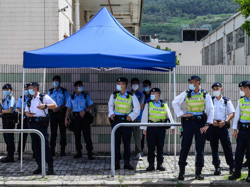 Police stand guard near the offices of the local Apple Daily newspaper in Hong Kong.