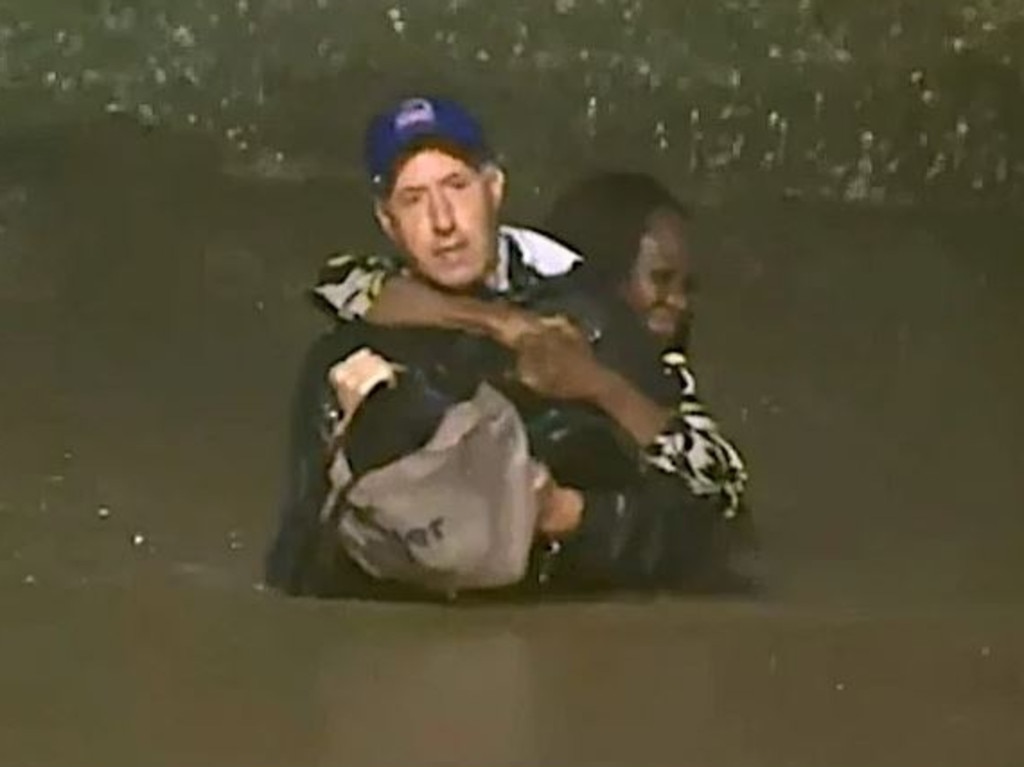 Meteorologist Bob Van Dillen rescued a woman during a live cross. Picture: FOX News