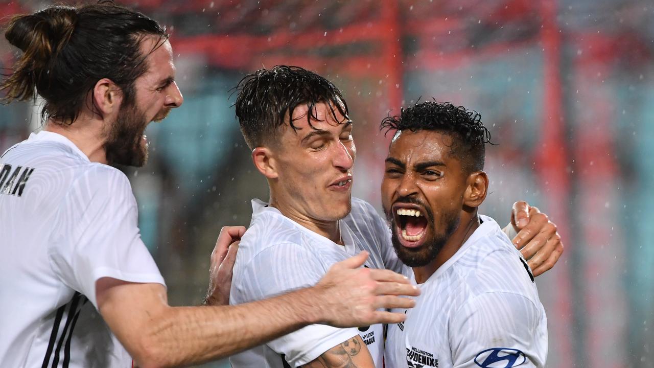 Roy Krishna (R) celebrates after scoring for the Phoenix against the Wanderers. 