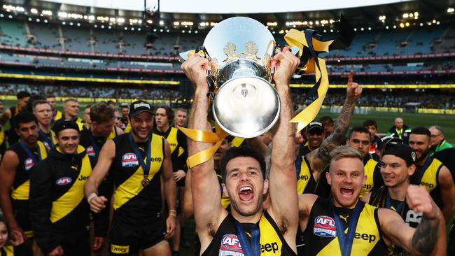 MELBOURNE, AUSTRALIA - SEPTEMBER 28: Captain Trent Cotchin of the Tigers celebrates victory with team mates after the 2019 AFL Grand Final match between the Richmond Tigers and the Greater Western Sydney Giants at Melbourne Cricket Ground on September 28, 2019 in Melbourne, Australia. (Photo by Matt King/AFL Photos/via Getty Images )