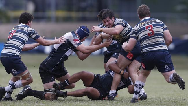 Ethan Dobbins of Brothers is tackled by Joseph Avauli and Callum MacDonald of Souths during the Under-19 rugby union match last year. (AAP Image/Regi Varghese)