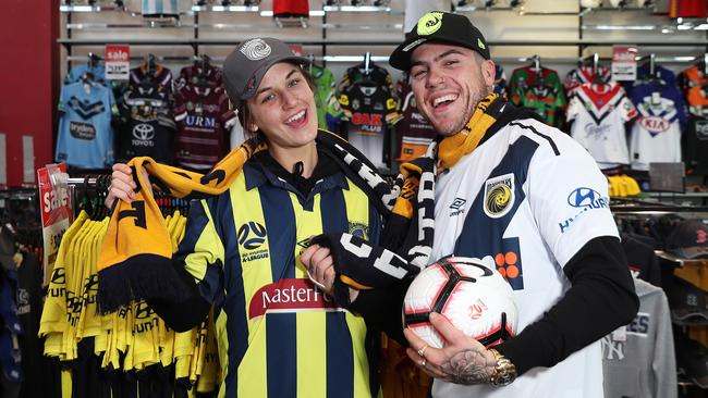 Jazmin Butler and Tyler Reeves try out Central Coast Mariners gear at Rebel in Erina Fair ready for the arrival of Usain Bolt. Picture: Brett Costello