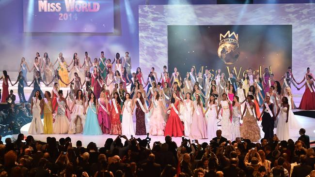 All contestants hold hands after Miss South Africa and the 2014 Miss World, Rolene Strauss (C), was crowned during the grand final of the Miss World 2014 pageant at the Excel London ICC Auditorium in London. AFP PHOTO / LEON NEAL