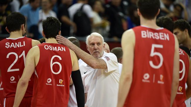 Team USA coach Gregg Popovich consoles the Turkish players.