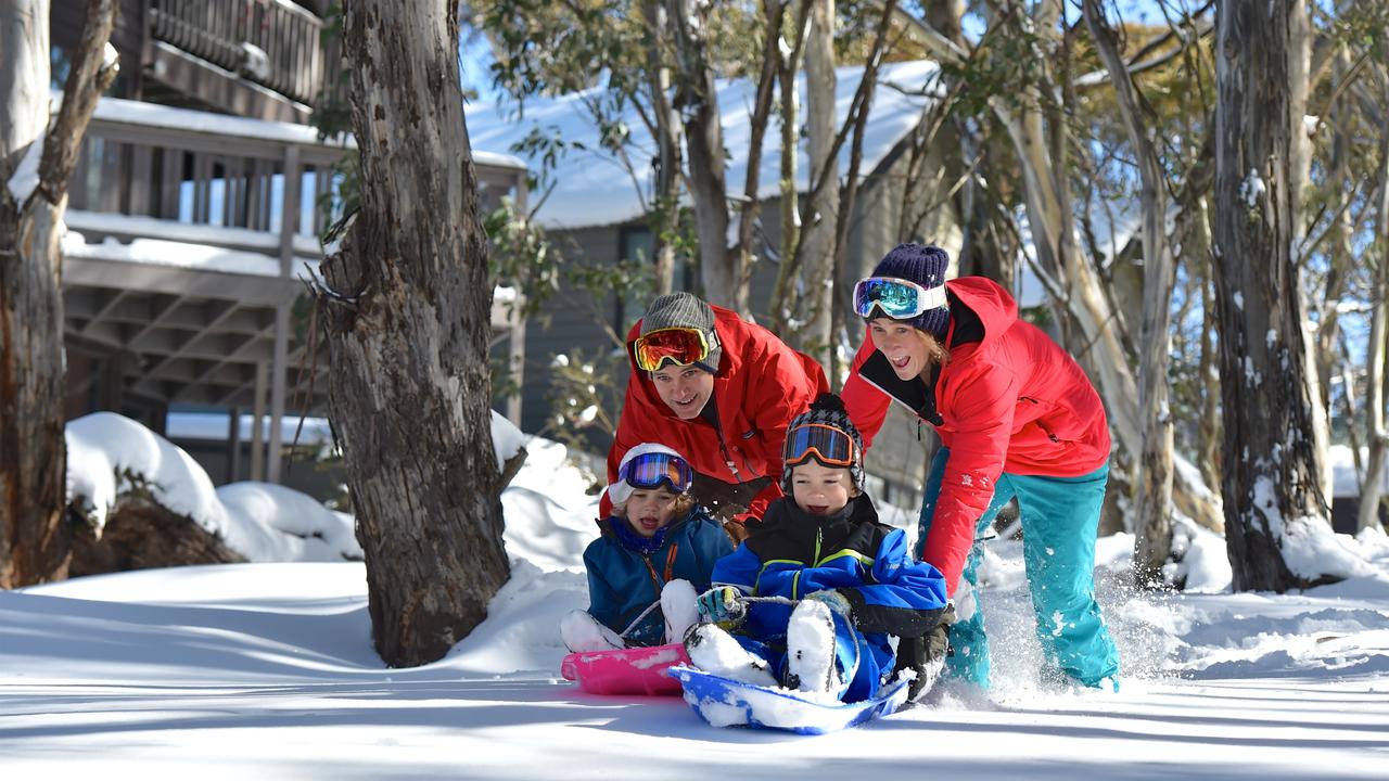 A family tobogganing at Dinner Plain, Victoria. Image: Supplied