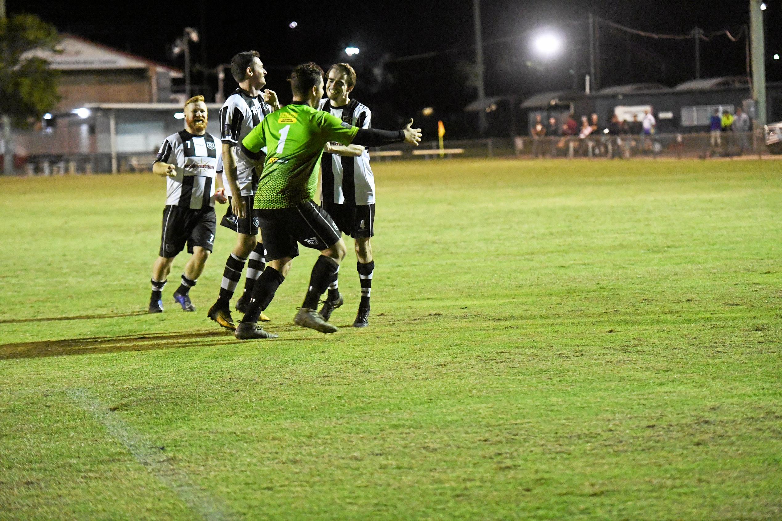 Bingera players celebrate with goalkeeper Jason McEwan after he helped the side to a win in the Triple M Division 1 Cup against The Waves. Picture: Shane Jones