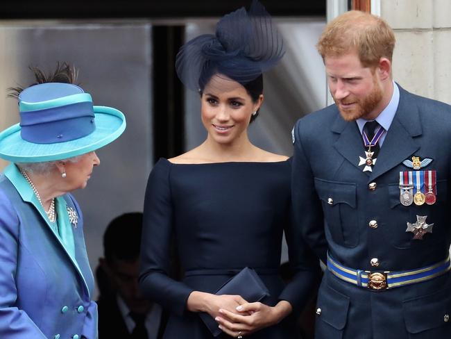 The Queen, left, has said she would prefer that Meghan Markle, centre, and Prince Harry remain as full-time royals. Picture: Getty Images