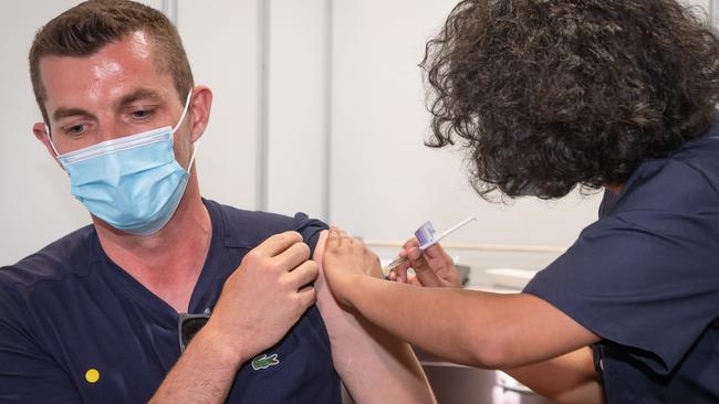 Nurse Onyinyechi Okorie administer the COVID vaccine as Phase 1B got underway. Picture: Jason Edwards