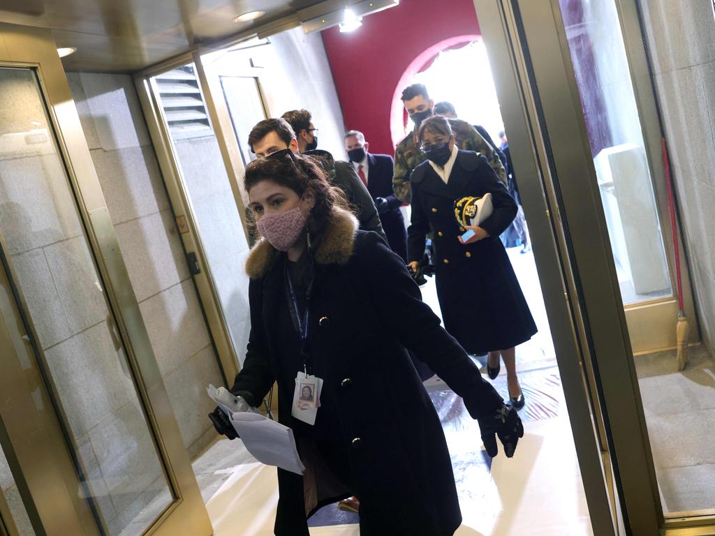 Attendees of Joe Biden’s inauguration rehearsal are evacuated after a fire threat. Picture: AFP