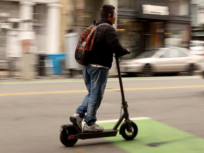 SAN FRANCISCO, CALIFORNIA - JULY 29: A man rides an electric scooter along Polk Street on July 29, 2024 in San Francisco, California. According to a University of California San Francisco (UCSF) study, injuries involving e-bikes surged more than 3,000% across the country between 2017 and 2022, and e-scooter injuries jumped more than 560% during the same time.   Justin Sullivan/Getty Images/AFP (Photo by JUSTIN SULLIVAN / GETTY IMAGES NORTH AMERICA / Getty Images via AFP)