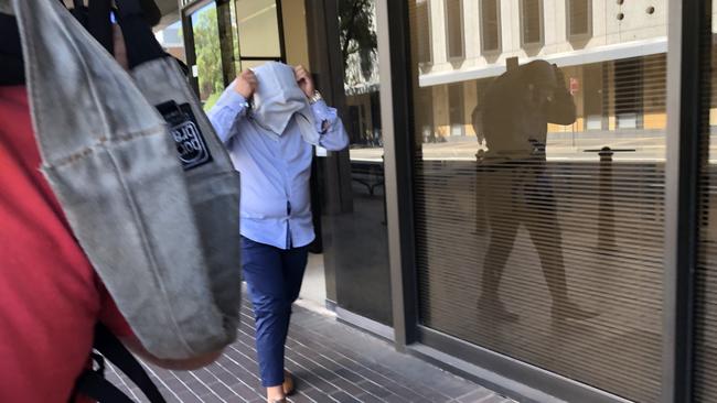 Abraham Zreika covers his face as he leaves Parramatta Local Court. Picture: Joanne Vella