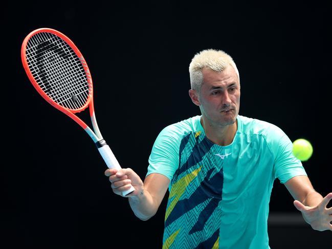 MELBOURNE, AUSTRALIA - JANUARY 11:  Bernard Tomic of Australia plays a forehand in his match against Roman Safiullin of Russia during day two of 2022 Australian Open Qualifying at Melbourne Park on January 11, 2022 in Melbourne, Australia. (Photo by Graham Denholm/Getty Images)