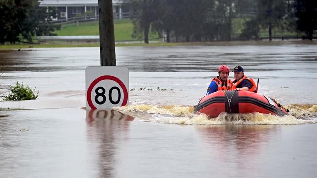 An SES boat patrols the flooded waterways of the Hawkesbury River in Vineyard during the NSW floods.