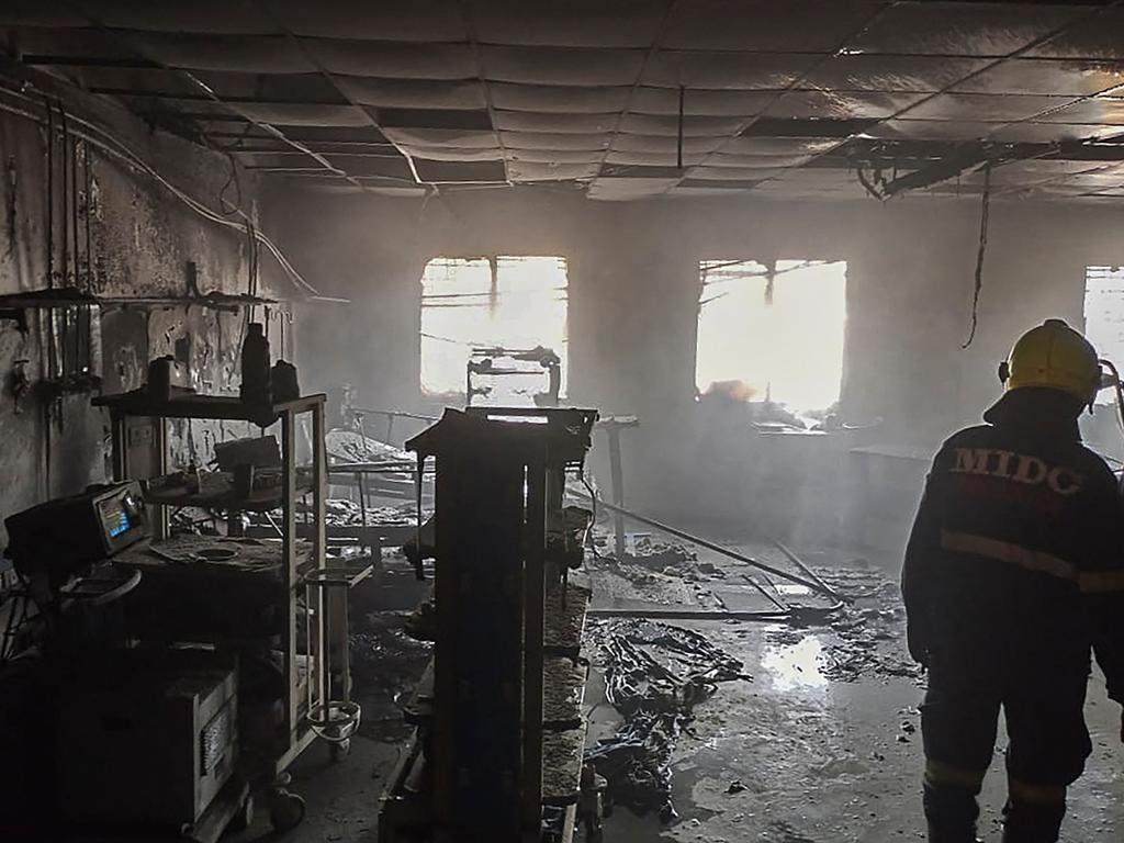 Firefighters inspect a ward after a fire broke out at a Covid hospital in Ahmednagar district, India, killing at least 11 people. Picture: AFP