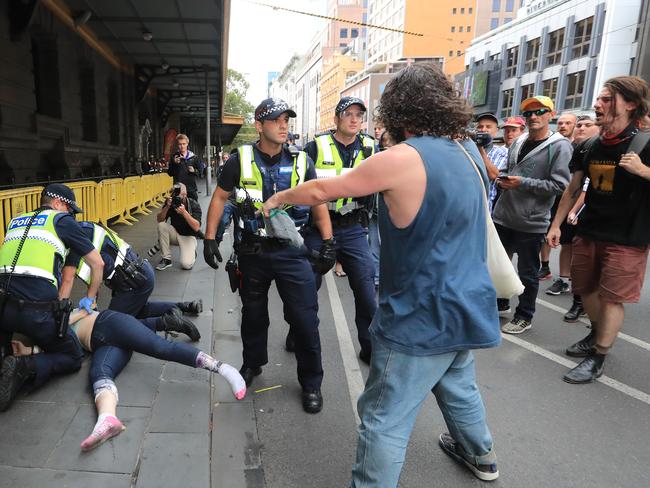 Police face protesters at Flinders St Station. Picture: Alex Coppel