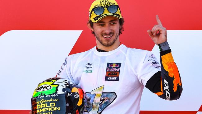 Kalex Red Bull KTM Ajo Australian rider Remy Gardner celebrates his Moto2 2021 World Champion title, after the Moto2 race of the Valencia Grand Prix at the Ricardo Tormo racetrack in Cheste, on November 14, 2021. (Photo by JOSE JORDAN / AFP)