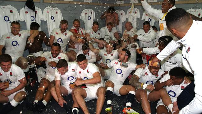 England celebrate in the dressing room after their series victory.