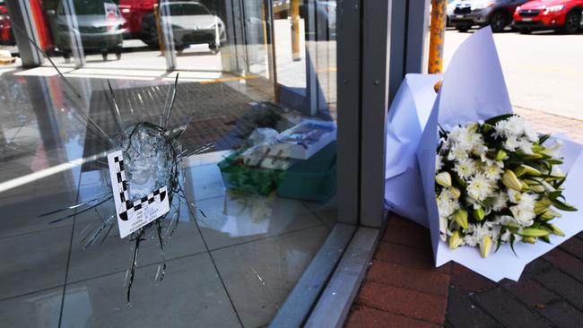 A bouquet of flowers sit at the scene of the shooting