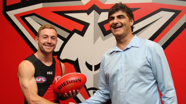 Former GWS Giants midfielder Devon Smith shakes hands with Adrian Dodoro after joining Essendon. Picture: Supplied