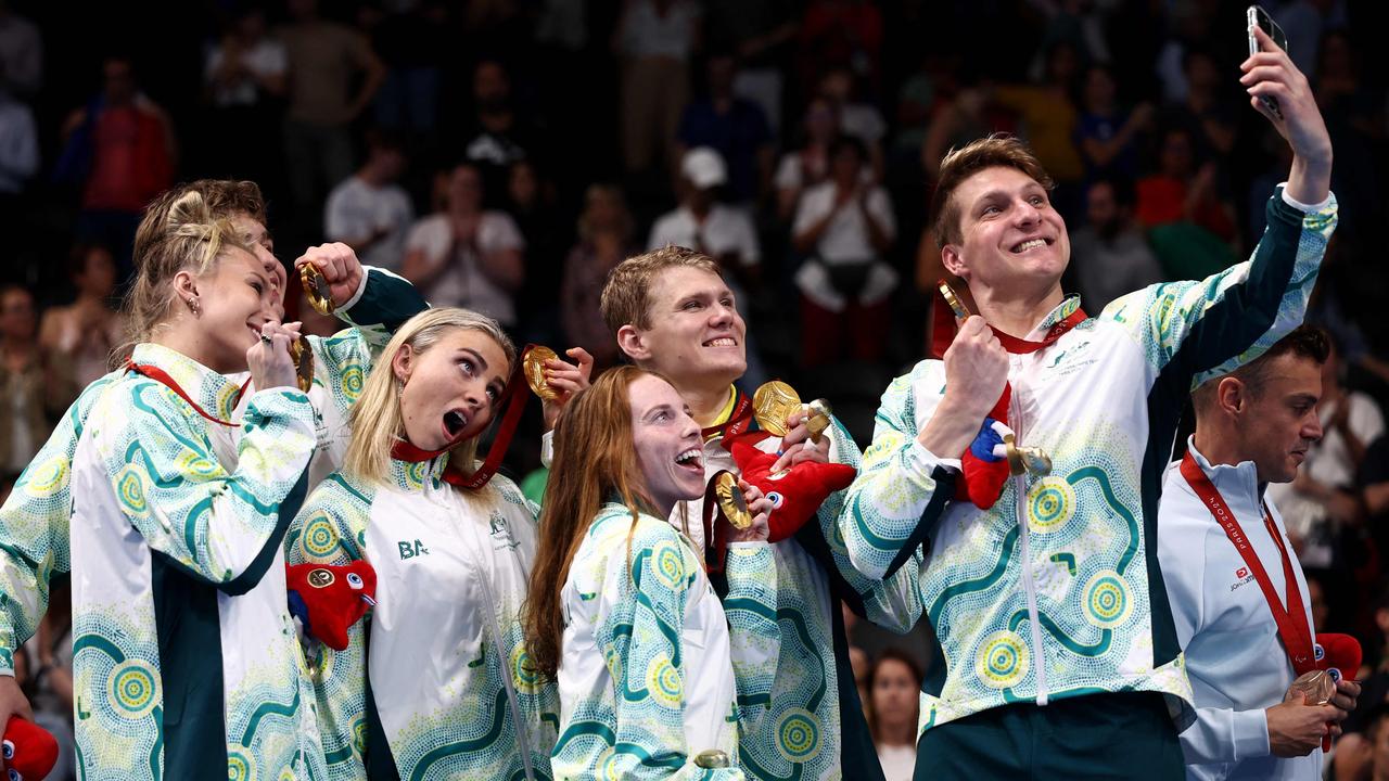 Gold medallists for Australia, Jesse Aungles, Keira Stephens, Emily Beecroft, Callum Simpson, Timothy Hodge and Alexa Leary pose for selfies as they celebrate their victory ceremony for the mixed 4x100m medley relay final at the Paris La Defense Arena on September 2. Picture: Franck Fife/AFP