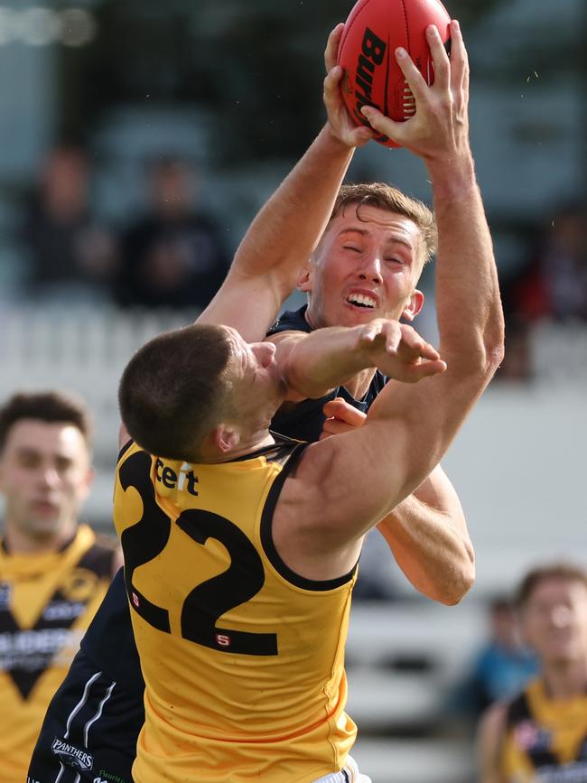 Glenelg’s Matthew Allen takes a strong mark under pressure from South Adelaide’s Kobe Mutch at Noarlunga Oval on Saturday. Picture: SANFL Image/David Mariuz