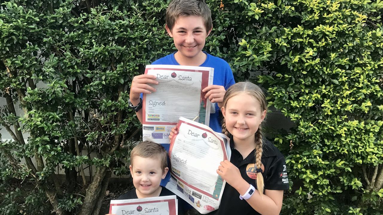 DEAR SANTA: Lachlan, 3, Jayden, 15, and Emma, 7, Zenovich have their Santa letters ready to send off to the North Pole.