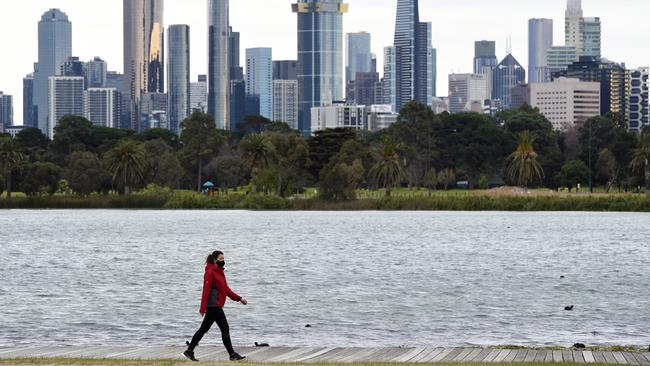 A person walks around Albert Park Lake in Melbourne on Tuesday. Picture: Andrew Henshaw