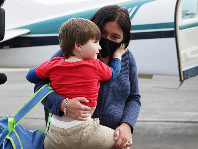 Relieved mother Dominique Facer carries Memphis after they were reunited by Angel Flight last Friday. Since then, more people have reached out to Angel Flight for assistance. Picture Lachie Millard