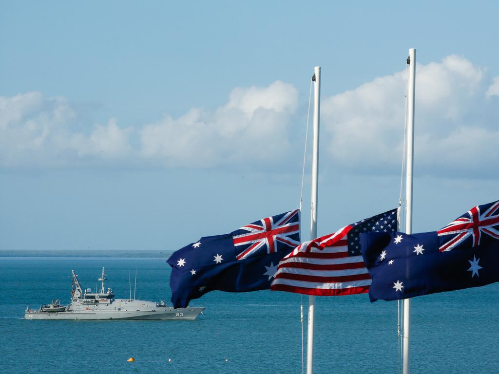 HMAS Armidale marks the spot where the USS Peary was sunk on February 19 1942, while flags fly at half mast during the 77th Anniversary of the Bombing of Darwin special commemorative service in Darwin, Tuesday, February 19, 2019. (AAP Image/GLENN CAMPBELL) 