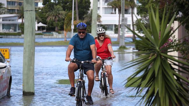 Flooding from the King tide at Budds Beach at Surfers Paradise was made worse by the approaching storm system. Gotta watch where you ride. Picture Glenn Hampson