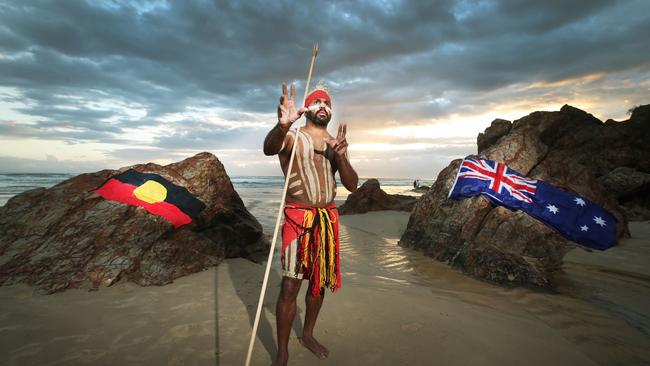 Indigenous dancer Jay Thompson remembers his ancestors’ history at dawn at Miami beach on the Gold Coast. Picture Glenn Hampson