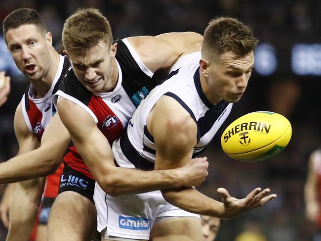 MELBOURNE, AUSTRALIA - MAY 14: Shaun Higgins of the Cats is tackled by Dougal Howard of the Saints during the 2021 AFL Round 09 match between the St Kilda Saints and the Geelong Cats at Marvel Stadium on May 14, 2021 in Melbourne, Australia. (Photo by Dylan Burns/AFL Photos via Getty Images)