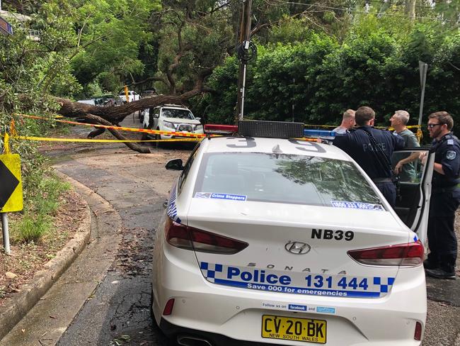 Residents of Kookaburra Cl, Bayview, talk to police at the cordoned off entrance to their street. Picture: Jim O'Rourke.