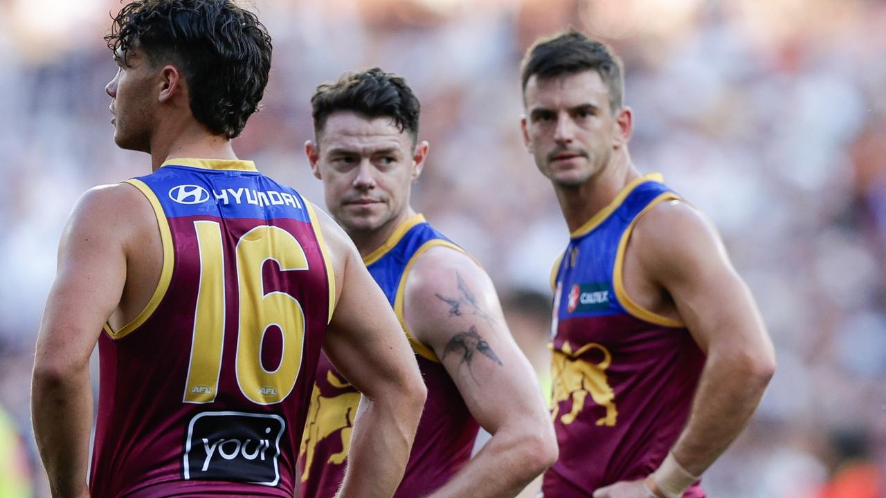 The faces of Cam Rayner, Lachie Neale and Jarryd Lyons say it all after the 2023 grand final. Picture: Russell Freeman/AFL Photos via Getty Images