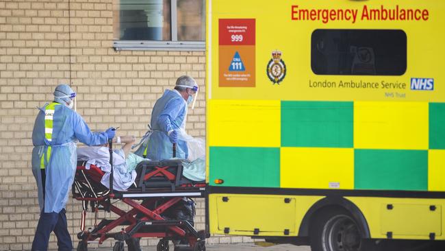 NHS workers in take a patient with an unknown condition to an ambulance at Queens Hospital in London. Picture: Getty