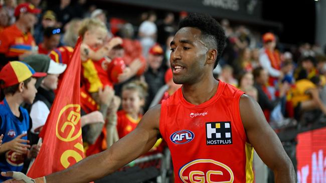 Hewago Paul Oea of the Suns celebrates wth fans. Picture: Matt Roberts/AFL Photos/via Getty Images